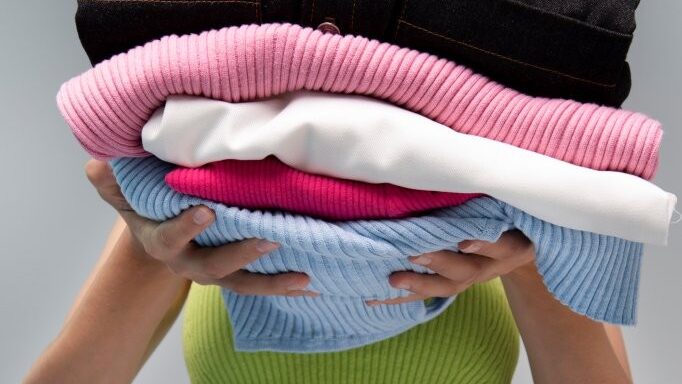 front-view-woman-holding-clothes